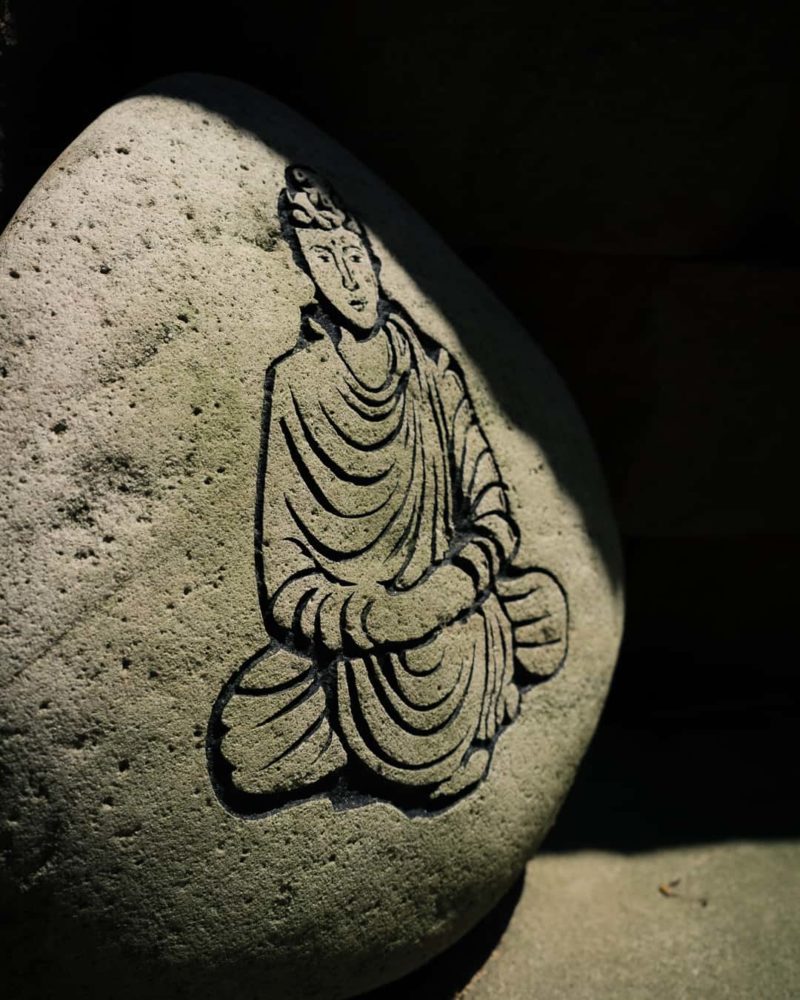 a symbol of buddha carved into a rock at shoji spa