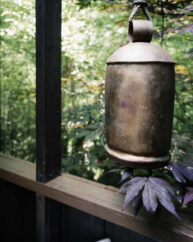 a bell hanging on the porch at shoji spa